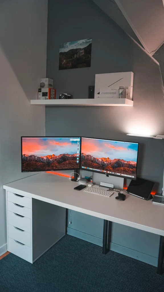 Clean home office desk with two monitors on a dual monitor arm