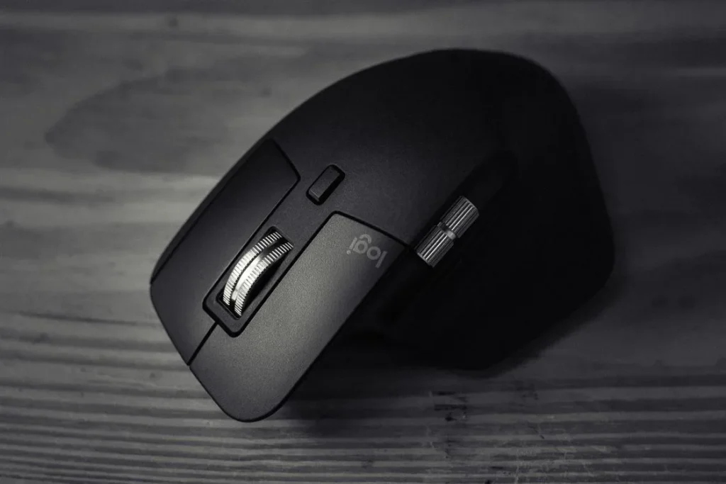 Close-up of an ergonomic sculpted computer mouse on a wooden desk