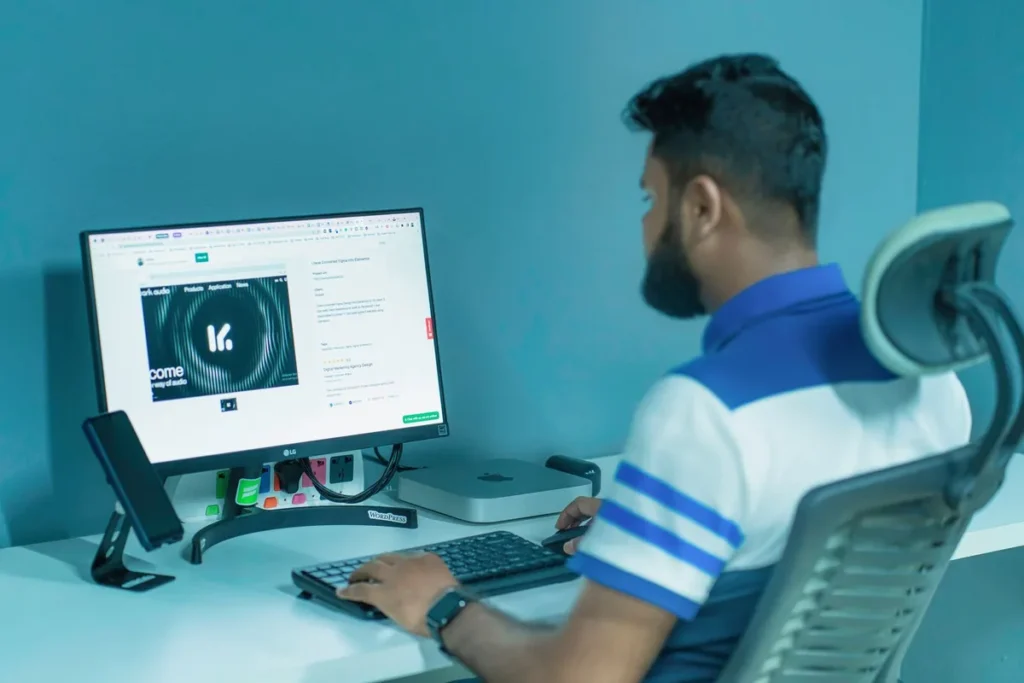 Man sitting with good posture in an ergonomic office chair at a computer desk